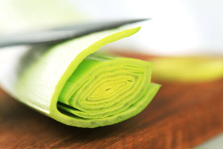 Detail of fresh leek stalk on a cutting board