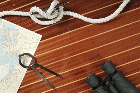 Nautical divider on a chart, rope and binoculars の写真素材