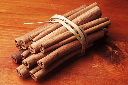 Bundle of cinnamon sticks tied up with a straw