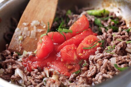 Preparing Bolognese sauce for pasta の写真素材