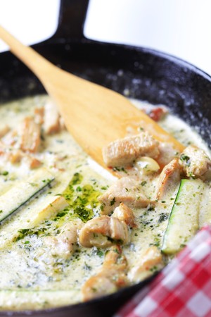 Preparing a sauce and meat for a pasta dishの写真素材