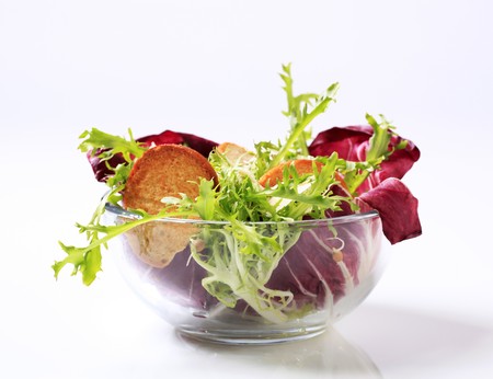 Bowl of green salad with crostini and cheeseの写真素材