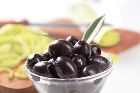 Pitted black olives in a glass bowlの写真素材