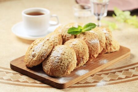 Rows of crispy cookies on a cutting board