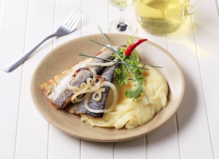 Pan fried trout with mashed potatoes and white wineの写真素材