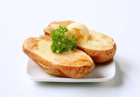 Butter curls melting on a baked potatoの写真素材