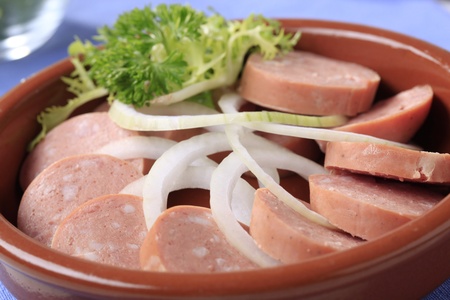 Dish of sliced sausages and onion - detailの写真素材
