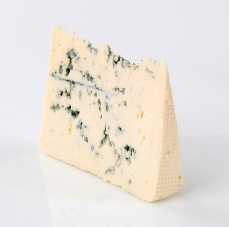Blue cheese with veins of green moldの写真素材