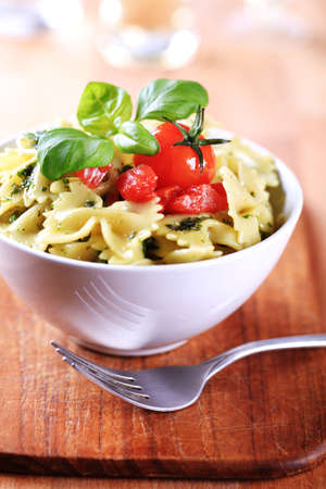 Bow tie pasta with pesto and tomatoの写真素材