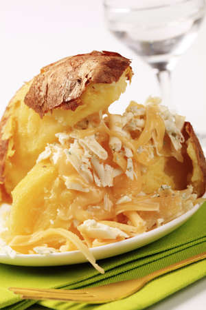 Baked potato sprinkled with two kinds of cheeseの写真素材