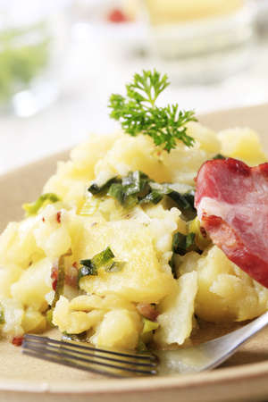 Crushed potatoes, spring onion and smoked porkの写真素材