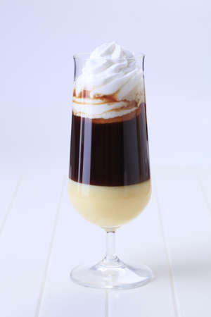 Glass of liqueur coffee with whipped cream 