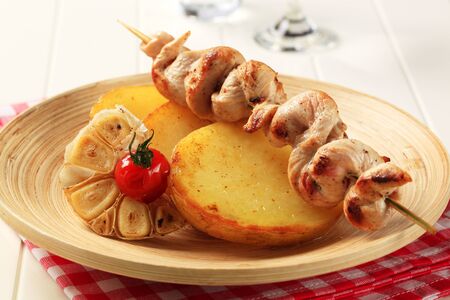 Chicken skewer on roasted potatoes - closeupの写真素材