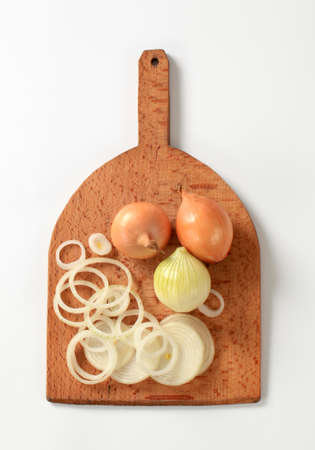 Fresh onion on a wooden cutting board の写真素材