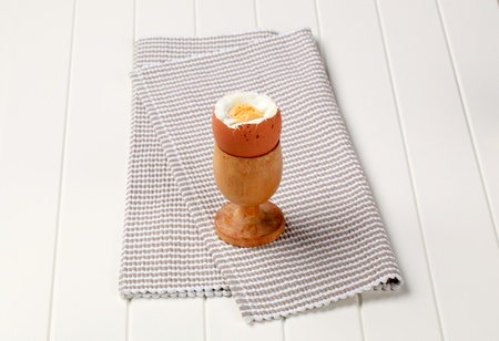 Boiled egg in a wooden eggcup 