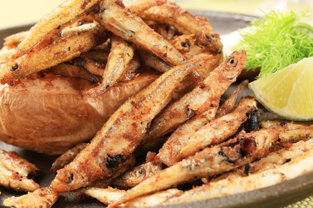 Fried anchovies and baked potato - detailの写真素材