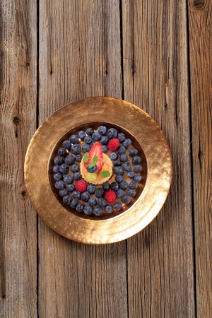 Custard filled puff pastry shell and fresh blueberriesの写真素材