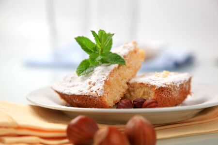 Slices of sponge cake sprinkled with icing sugarの写真素材