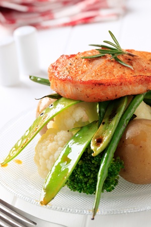 Marinated boneless pork chop served with vegetablesの写真素材