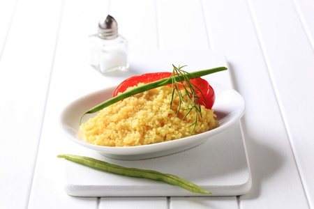 Side dish of couscous garnished with string beansの写真素材