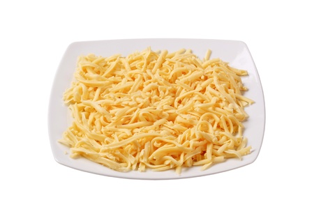 Plate of grated yellow cheese - studio