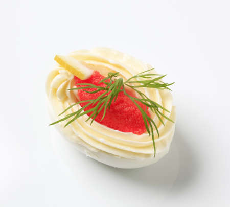 Egg white filled with creamy spread and caviarの写真素材