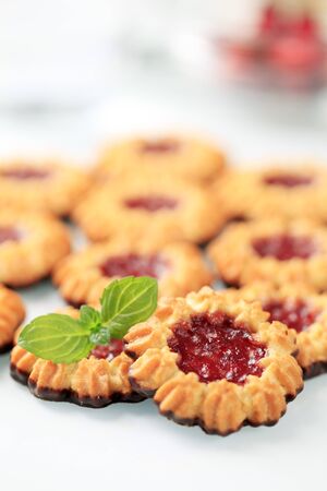 Chocolate dipped butter cookies with jelly centerの写真素材