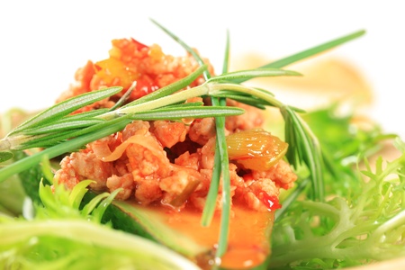 Avocado stuffed with minced meat garnished with curly endiveの写真素材