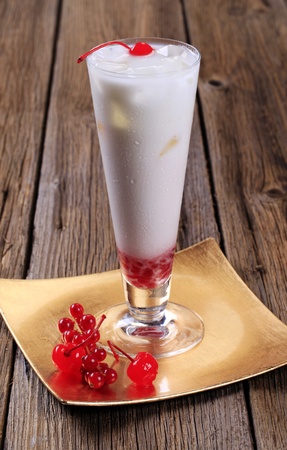 Coconut milk cocktail with red currant and maraschino cherriesの写真素材