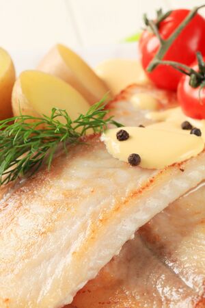 Pan fried fish fillets with potatoes and Hollandaise sauce