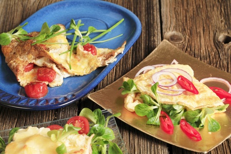 Egg omelets filled with tomatoes and salad greens