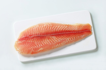 Raw fish fillet on cutting boardの写真素材