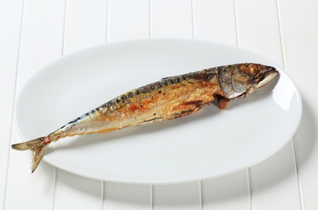 Grilled mackerel on white platterの写真素材