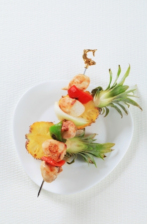 Chicken skewer on fresh pineappleの写真素材
