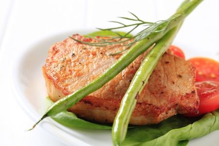 Marinated pork chop accompanied with vegetablesの写真素材