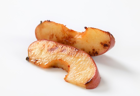 Pan fried apple slices on white backgroundの写真素材