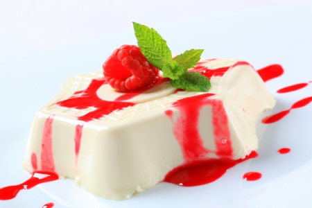Panna cotta with fruit coulis and raspberryの写真素材
