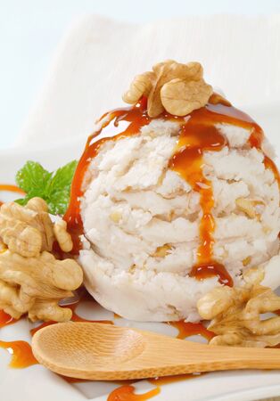 Scoop of walnut ice cream with caramel sauceの写真素材