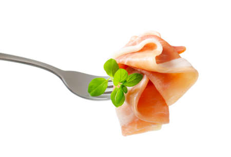 Thin slices of Prosciutto on a forkの写真素材