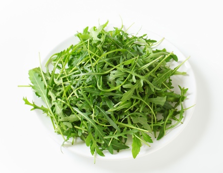 Arugula leaves on a plateの写真素材