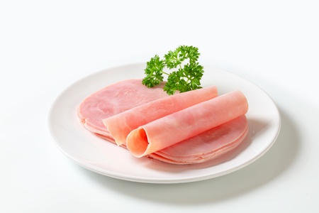 Thinly sliced ham on plateの写真素材