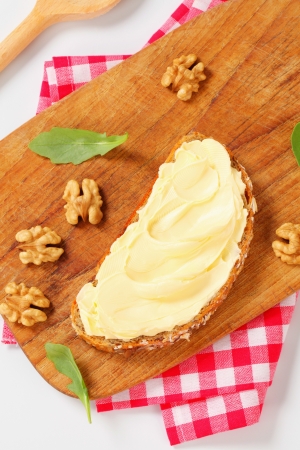 Slices of whole grain bread with butterの写真素材