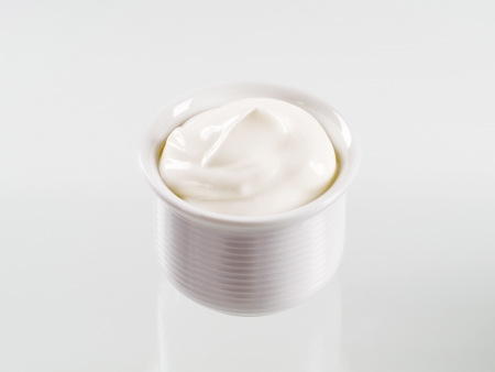 Studio shot of a bowl of sour cream の写真素材