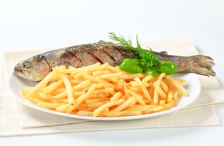 Dish of grilled trout and French friesの写真素材