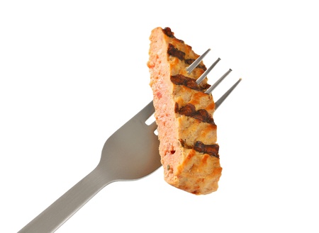 Strip of grilled burger on a forkの写真素材