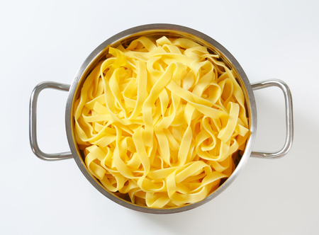 Cooked ribbon pasta in a potの写真素材
