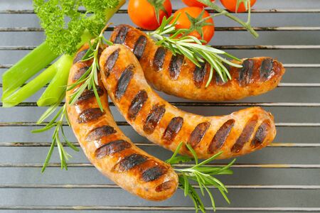 Grilled bratwursts on barbecue gridの写真素材