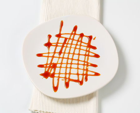 Caramel sauce on a plateの写真素材