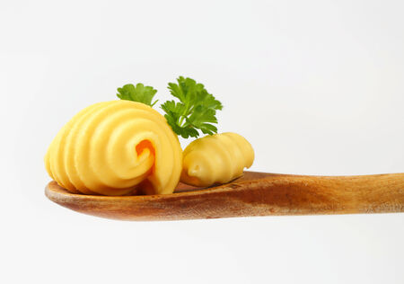 Butter curls on wooden spoonの写真素材