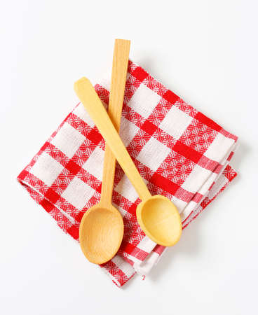 Red and white tea towel and wooden spoonsの写真素材